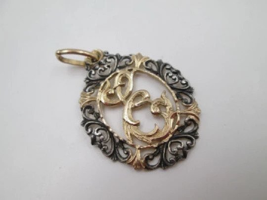 Anagram openwork medal. Sterling silver and vermeil. Vegetable edge. 1980's. Spain