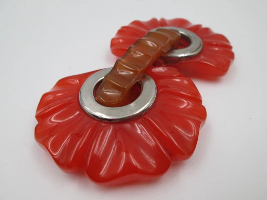 Art deco ladie's orange bakelite belt buckle. Flowers shape design. Silver metal details