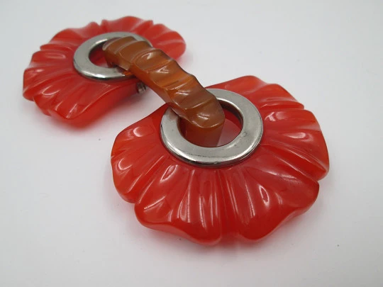 Art deco ladie's orange bakelite belt buckle. Flowers shape design. Silver metal details