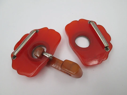 Art deco ladie's orange bakelite belt buckle. Flowers shape design. Silver metal details