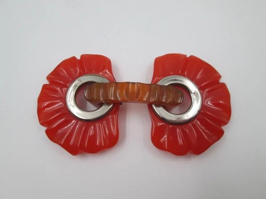 Art deco ladie's orange bakelite belt buckle. Flowers shape design. Silver metal details Art deco ladie's orange bakelite belt buckle. Flowers shape design. Silver metal details