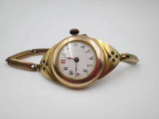 Art deco ladie's wrist watch. Gold plated. Porcelain sphere and white gems. 1920's