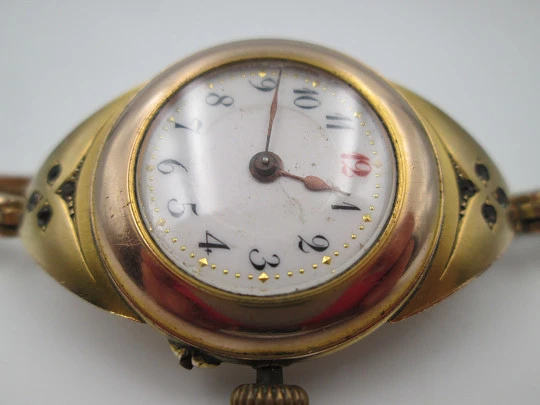 Art deco ladie's wrist watch. Gold plated. Porcelain sphere and white gems. 1920's