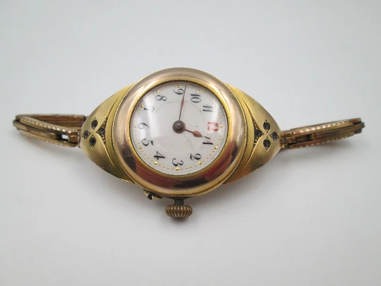 Art deco ladie's wrist watch. Gold plated. Porcelain sphere and white gems. 1920's