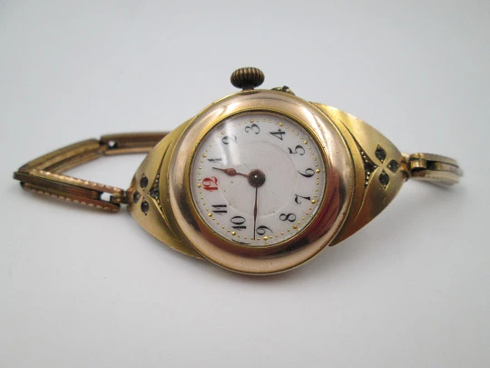 Art deco ladie's wrist watch. Gold plated. Porcelain sphere and white gems. 1920's