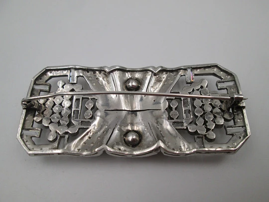Art deco women's brooch. Sterling silver and rhinestones. Openwork design. Europe. 1930s