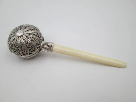 Baby rattle. Sterling silver. Openwork filigree sphere and ivory handle. 1970's