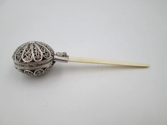 Baby rattle. Sterling silver. Openwork filigree sphere and ivory handle. 1970's