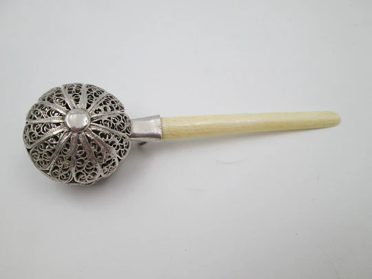 Baby rattle. Sterling silver. Openwork filigree sphere and ivory handle. 1970's