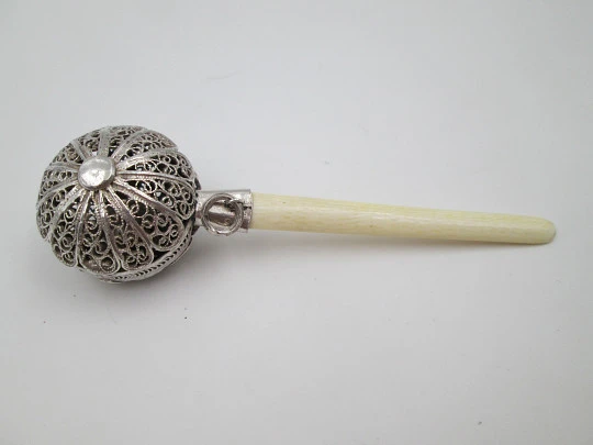 Baby rattle. Sterling silver. Openwork filigree sphere and ivory handle. 1970's