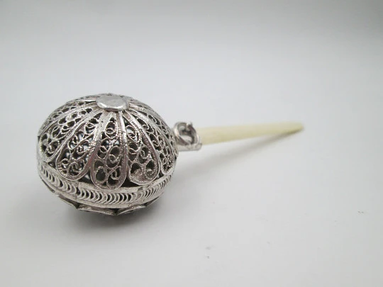 Baby rattle. Sterling silver. Openwork filigree sphere and ivory handle. 1970's