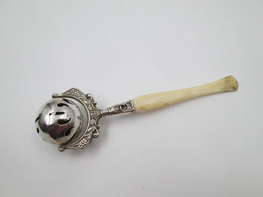 Baby rattle. Sterling silver. Openwork sphere and ivory handle. Box. 1960's. Floral motifs