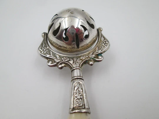 Baby rattle. Sterling silver. Openwork sphere and ivory handle. Box. 1960's. Floral motifs