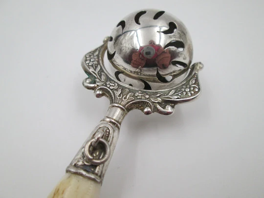 Baby rattle. Sterling silver. Openwork sphere and ivory handle. Box. 1960's. Floral motifs