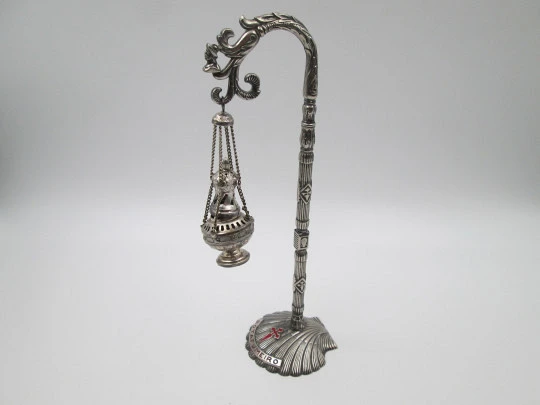 Botafumeiro en miniatura con soporte. Metal plateado. Conchas y cruces de Santiago. 1990