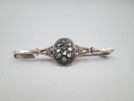 Broche para mujer. Plata de ley y gemas blancas. Adorno oval. Alfiler en reverso. 1970