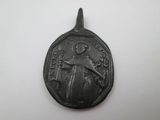 Bronze medal. Saint Michael and Jesus of Nazareth. High relief. Ring on top. 18th century