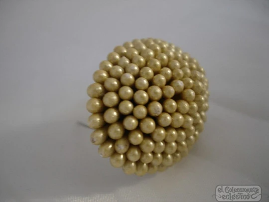 Brooch. Plated metal back. Small balls. Champagne colour. Resin