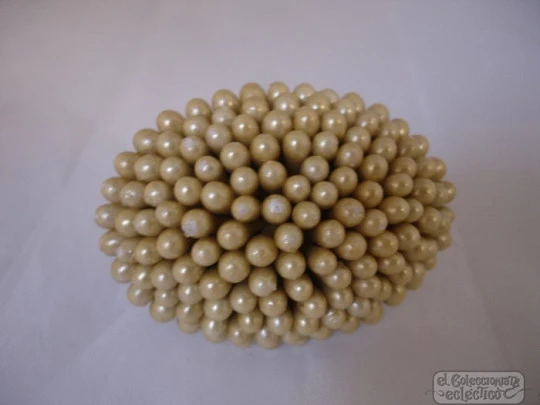 Brooch. Plated metal back. Small balls. Champagne colour. Resin