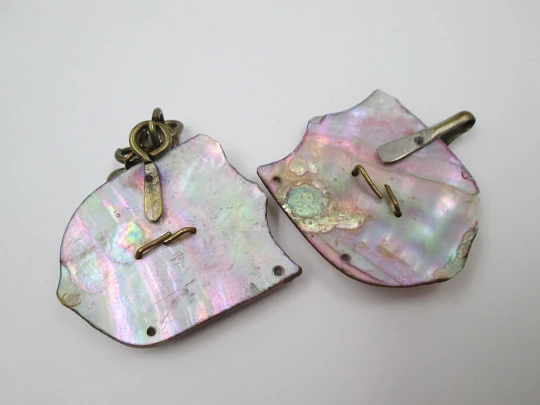 Cape clasp. Brass and mother-of-pearl. 1910-20. Man and woman