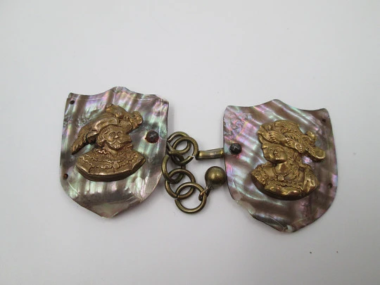 Cape clasp. Brass and mother-of-pearl. 1910-20. Man and woman