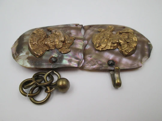 Cape clasp. Brass and mother-of-pearl. 1910-20. Man and woman