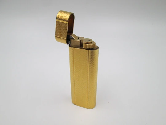 Cartier butane lighter. Yellow rolled gold. Waves pattern. Original box. France. 1990's