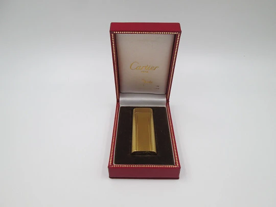 Cartier butane lighter. Yellow rolled gold. Waves pattern. Original box. France. 1990's