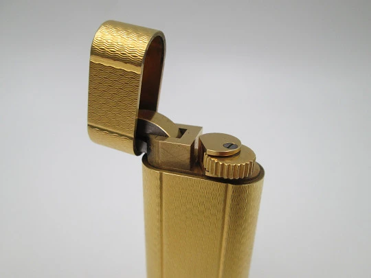 Cartier butane lighter. Yellow rolled gold. Waves pattern. Original box. France. 1990's
