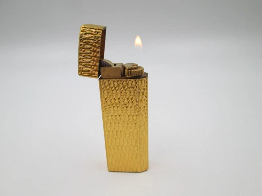 Cartier butane pocket lighter. Yellow rolled gold. Waves pattern. France. 1990's