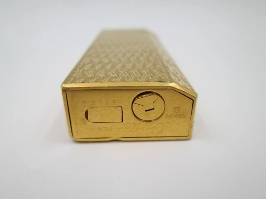 Cartier butane pocket lighter. Yellow rolled gold. Waves pattern. France. 1990's
