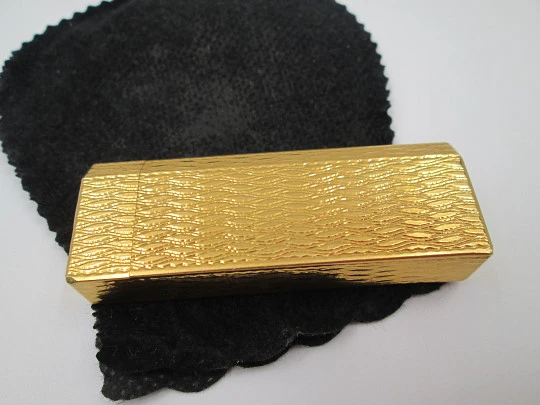 Cartier butane pocket lighter. Yellow rolled gold. Waves pattern. France. 1990's