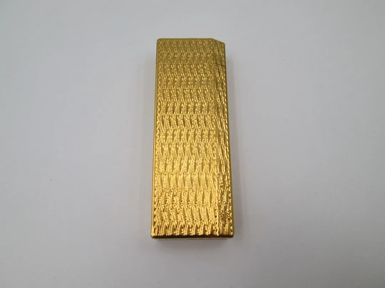 Cartier butane pocket lighter. Yellow rolled gold. Waves pattern. France. 1990's