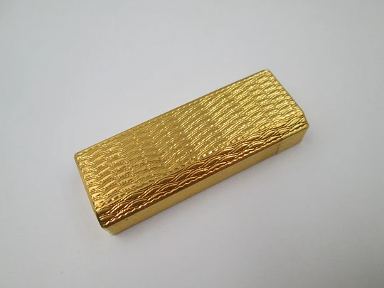 Cartier butane pocket lighter. Yellow rolled gold. Waves pattern. France. 1990's