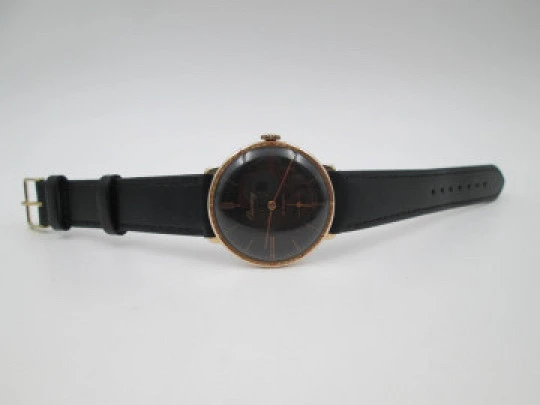 Cauny Prima De Luxe. 10 microns gold plated & steel. Manual wind. Black dial. 1970's. Swiss