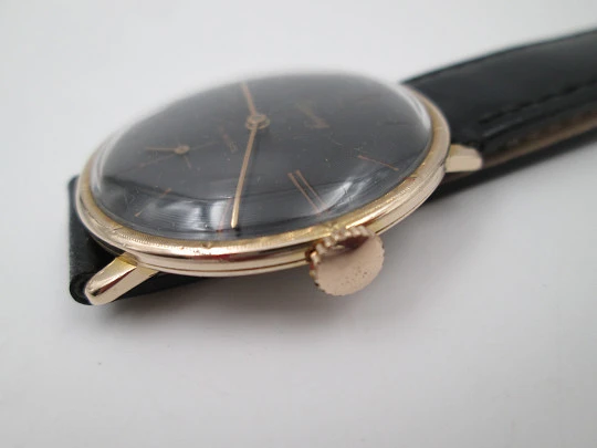 Cauny Prima De Luxe. 10 microns gold plated & steel. Manual wind. Black dial. 1970's. Swiss