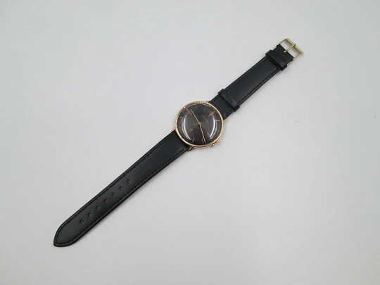 Cauny Prima De Luxe. 10 microns gold plated & steel. Manual wind. Black dial. 1970's. Swiss
