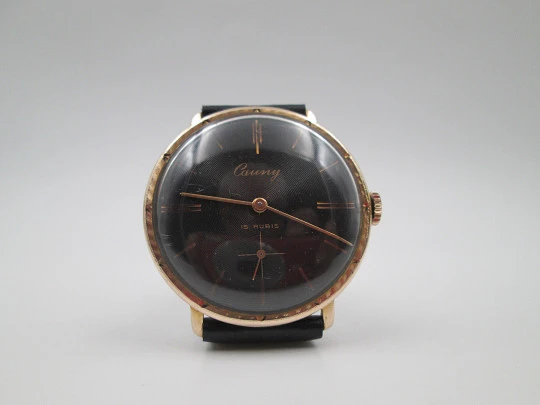 Cauny Prima De Luxe. 10 microns gold plated & steel. Manual wind. Black dial. 1970's. Swiss