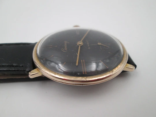 Cauny Prima De Luxe. 10 microns gold plated & steel. Manual wind. Black dial. 1970's. Swiss