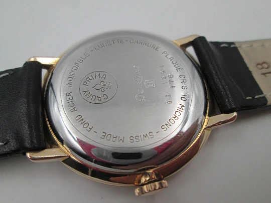 Cauny Prima De Luxe. 10 microns gold plated & steel. Manual wind. Black dial. 1970's. Swiss