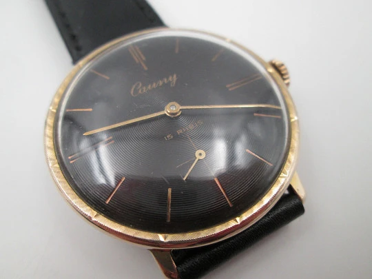 Cauny Prima De Luxe. 10 microns gold plated & steel. Manual wind. Black dial. 1970's. Swiss