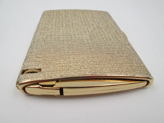 Cigarette case with petrol lighter. Gold plated metal. Grainy texture front. Box. 1960's