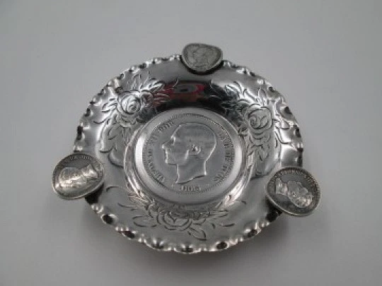 Circular ashtray, Alfonso XII coins and floral motifs. Sterling silver. 1970's