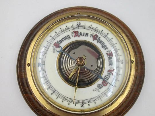 Circular wall barometer. Wood and brass bezel. White porcelain dial. West Germany. 1960's