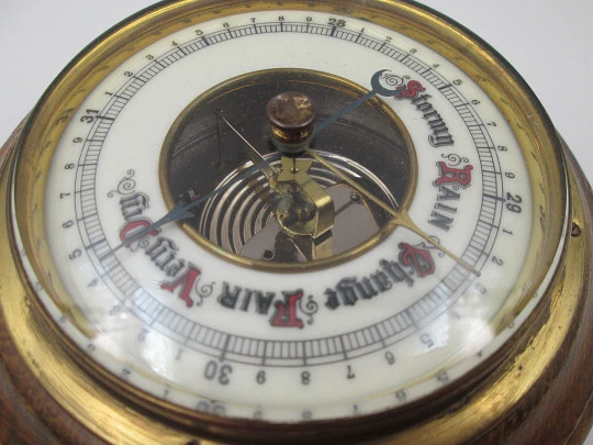 Circular wall barometer. Wood and brass bezel. White porcelain dial. West Germany. 1960's
