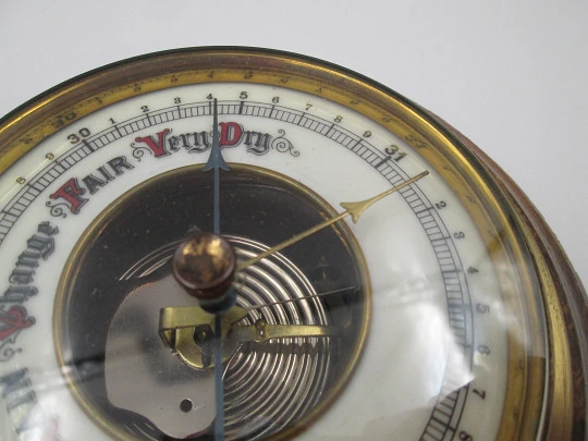 Circular wall barometer. Wood and brass bezel. White porcelain dial. West Germany. 1960's
