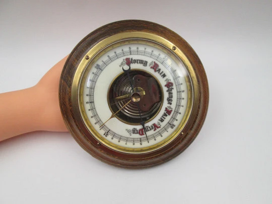 Circular wall barometer. Wood and brass bezel. White porcelain dial. West Germany. 1960's
