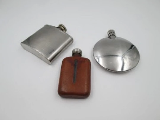 Collection three men's hip flasks. Stainless steel and leather. 1980's