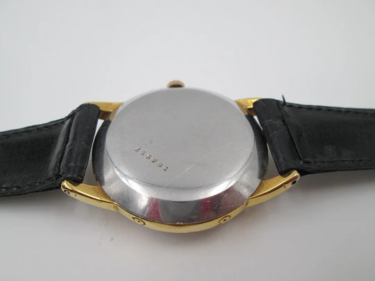 Coppel. Triple calendar & Moon phase. Steel and gold plated. Manual wind