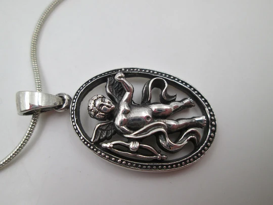 Cupid openwork oval pendant with cord. 925 sterling silver. Carabiner clasp. 1980's. Europe